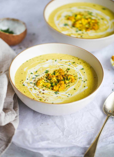Curried cauliflower soup in a white bowl