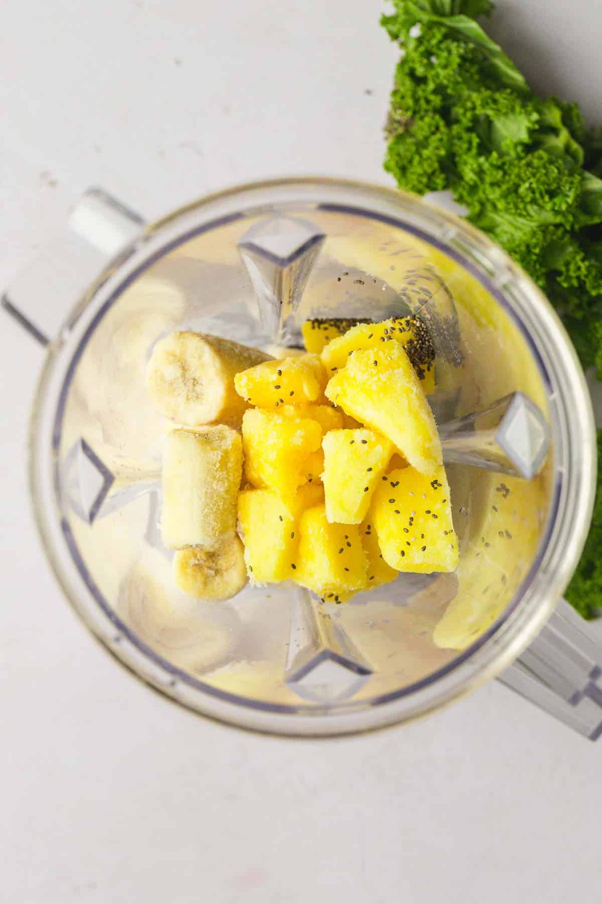 Kale Pineapple Smoothie ingredients in a blender before blending