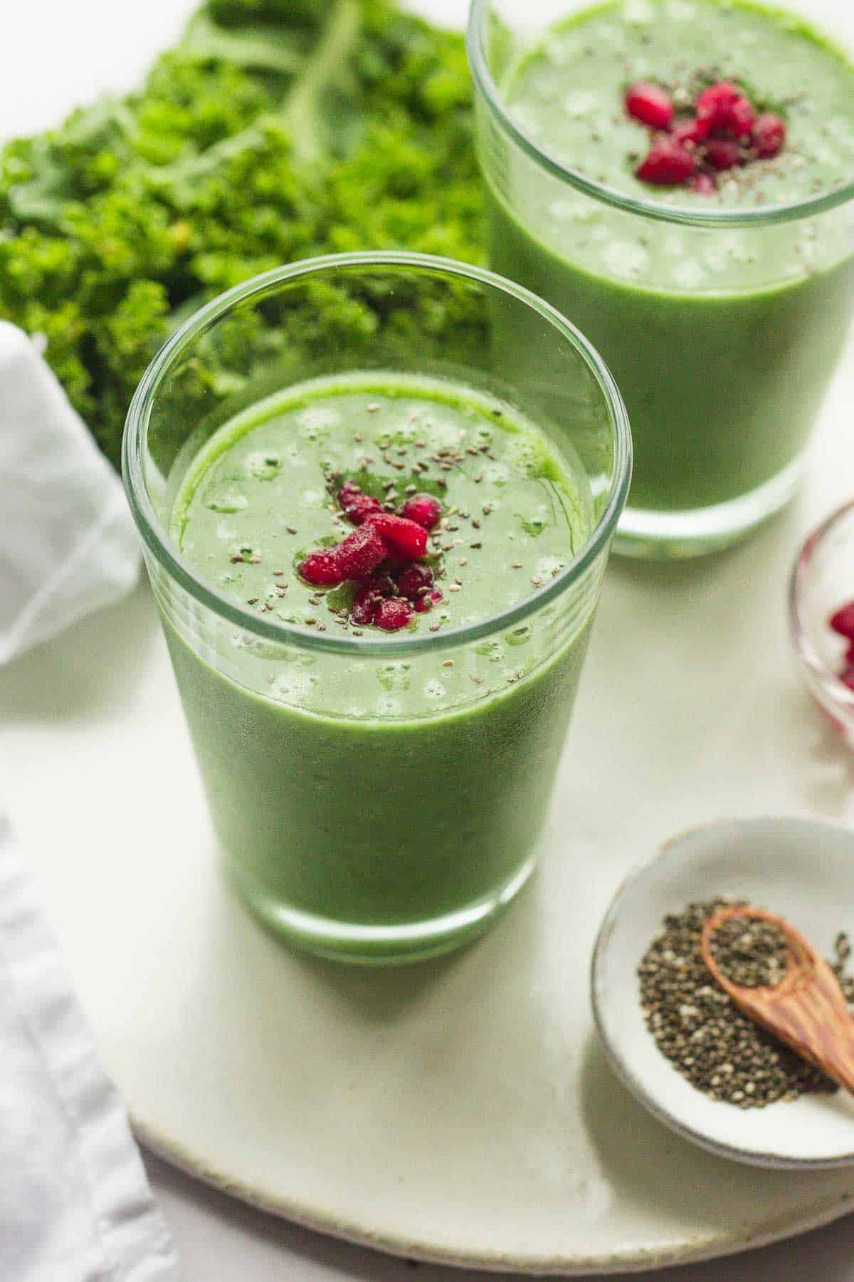 Kale Pineapple Smoothie in a glass with chia seeds and pomegranate seeds