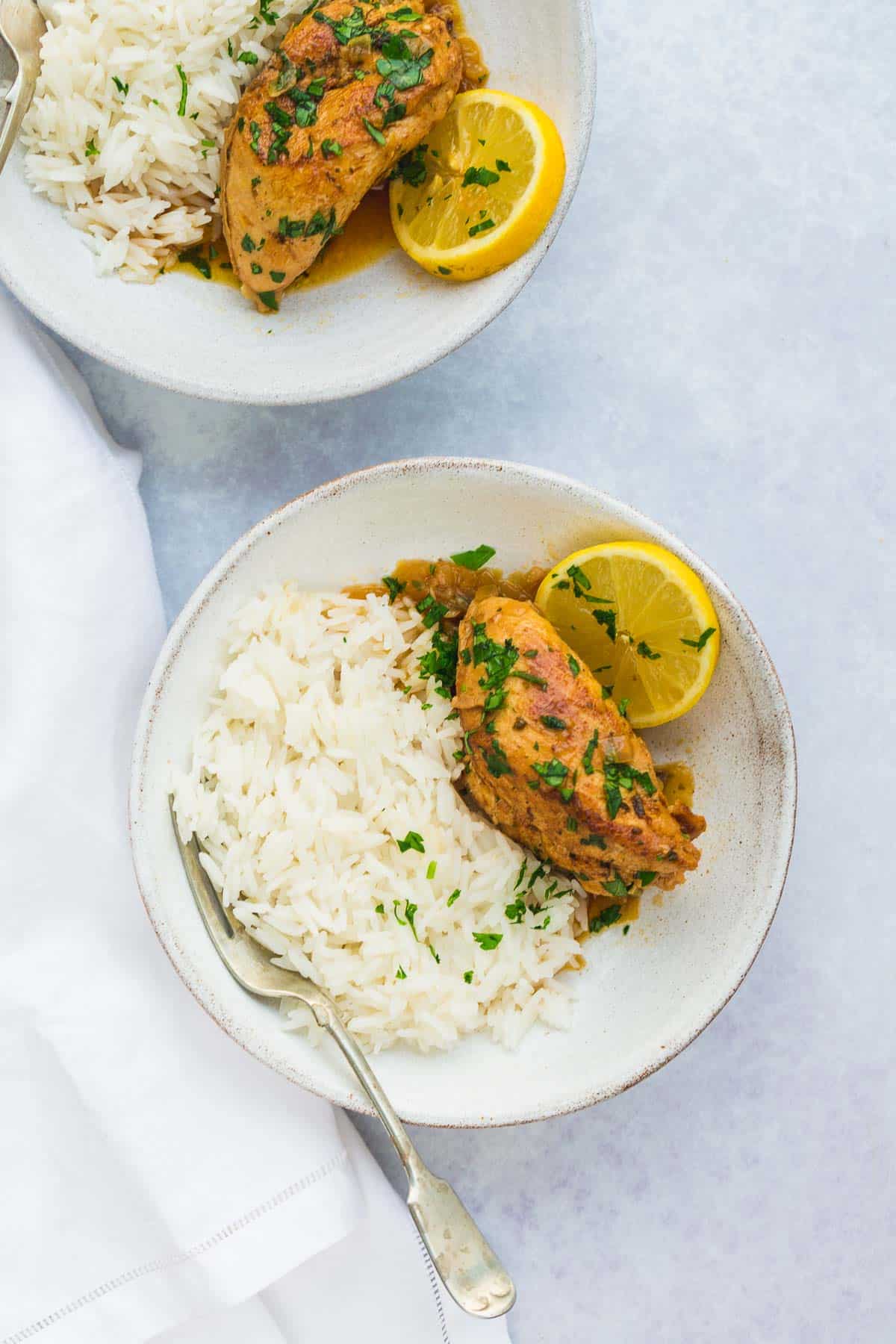 Instant Pot Lemon Garlic Chicken served over white rice in white bowls