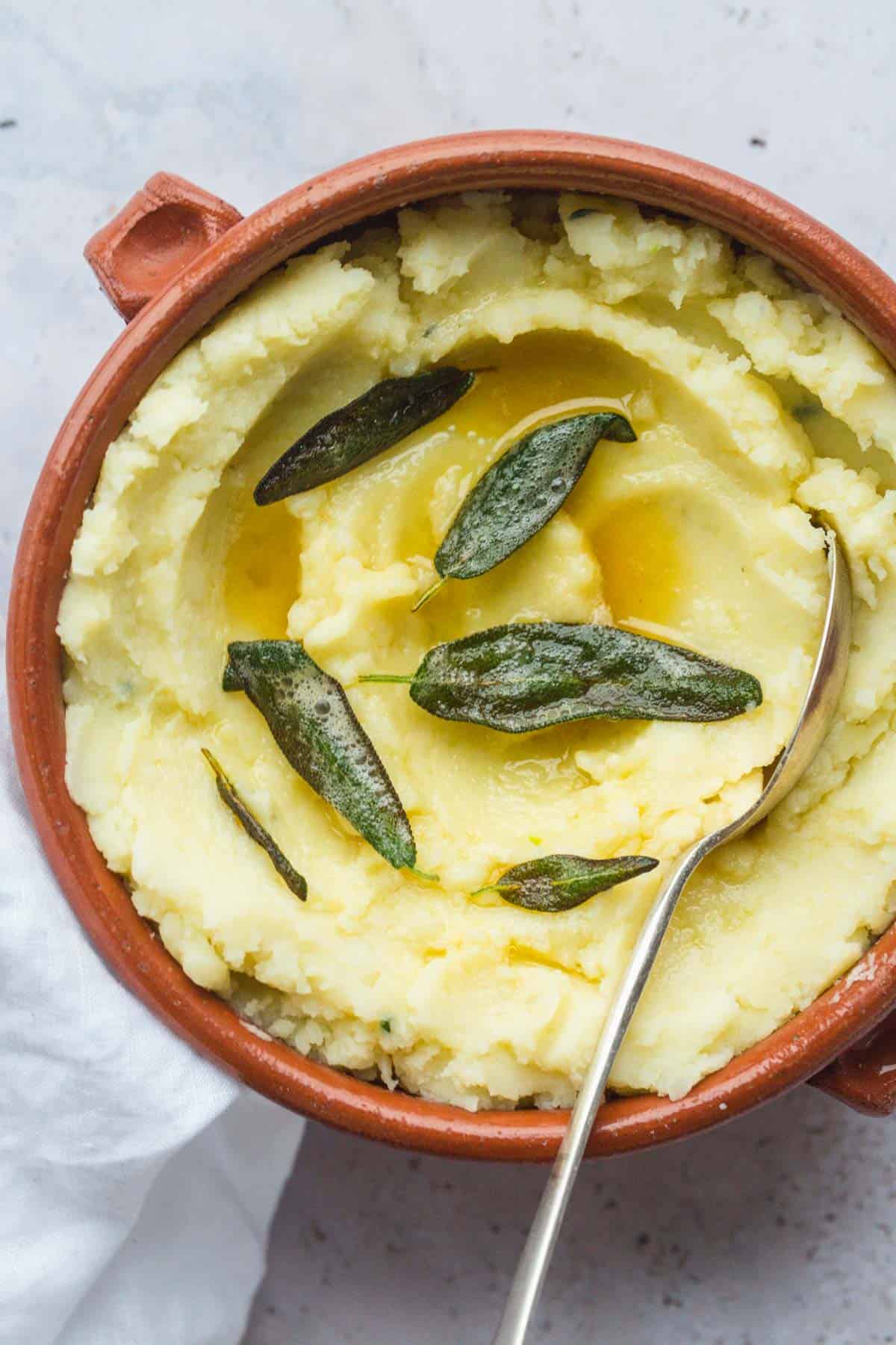 Vegan Mashed Potatoes served in a bowl and garnished with sage leaves