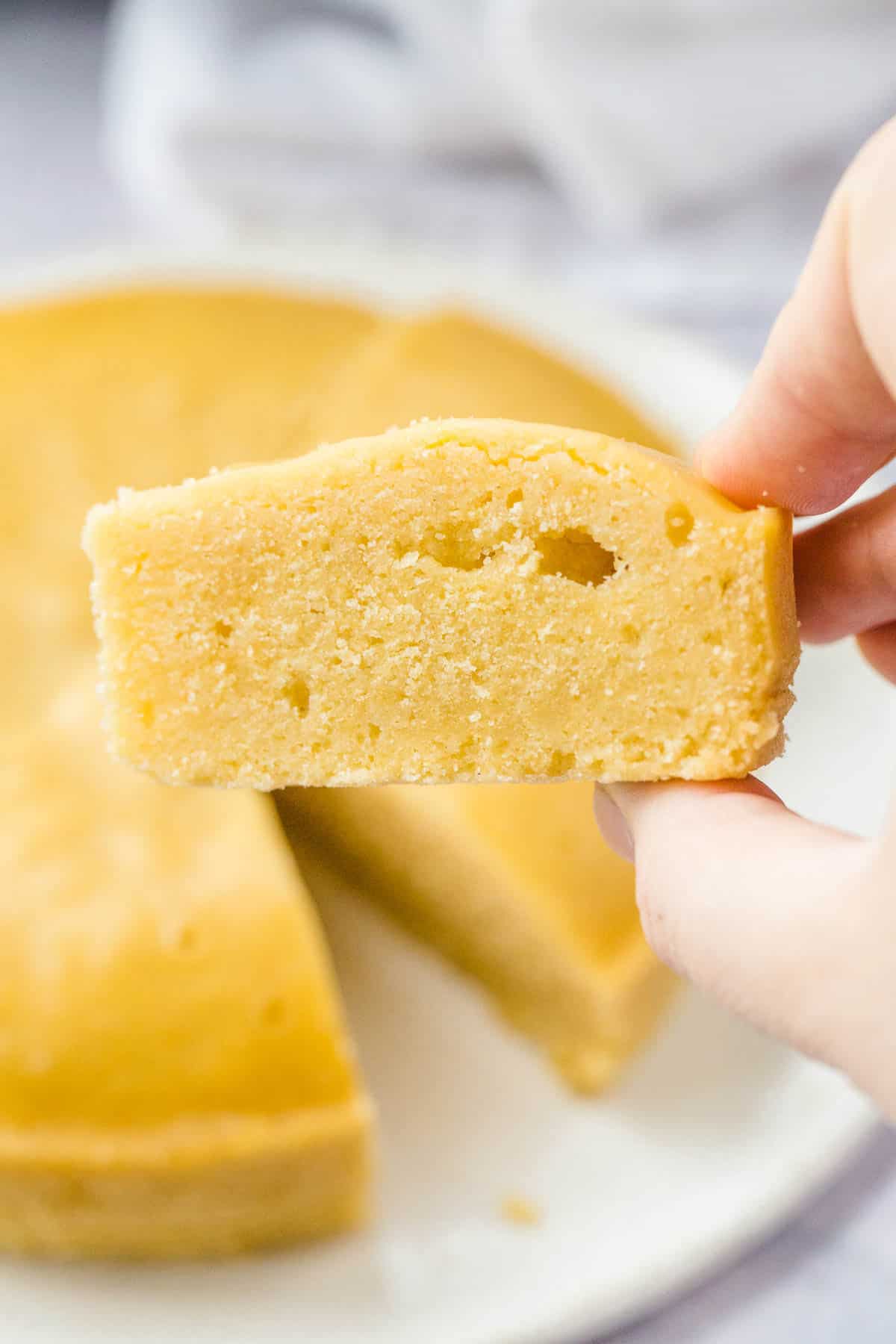 Holding a piece of cornbread in my hand to show the texture
