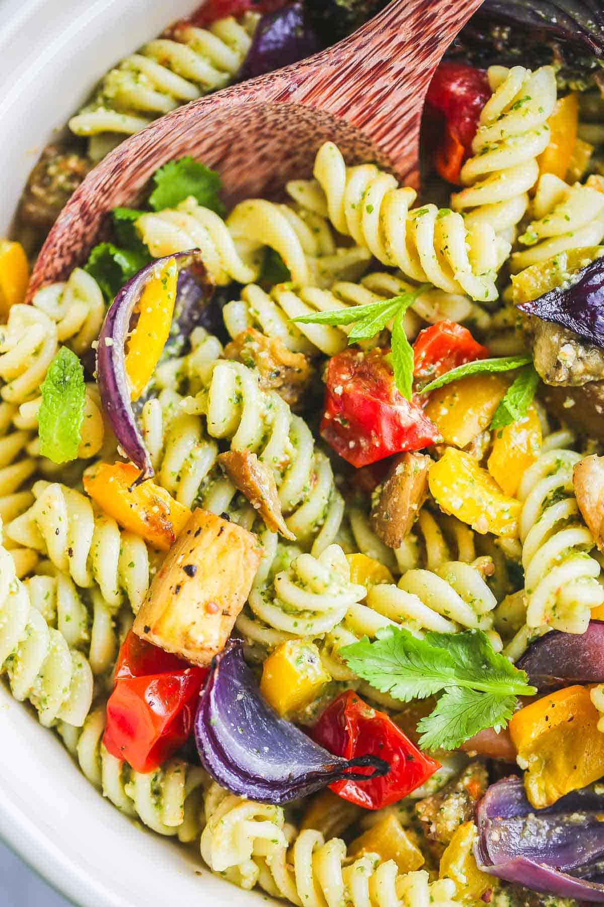 The colourful vegan pasta salad served in a large ceramic bowl