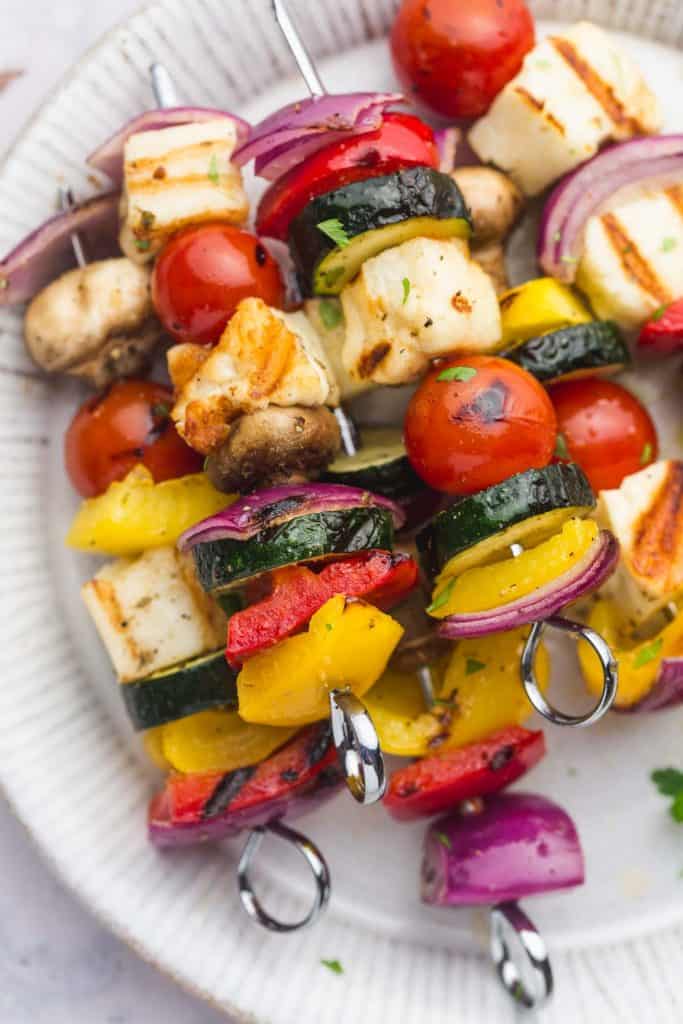Piled up veggie kabobs on a plate