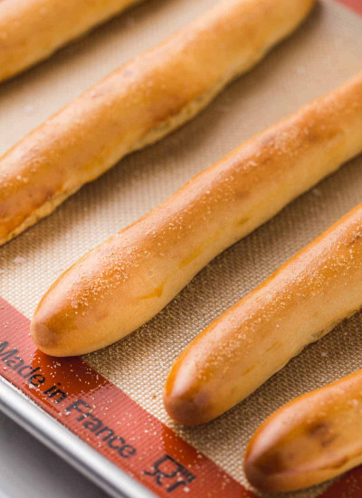Stacked breadsticks on a silicone mat