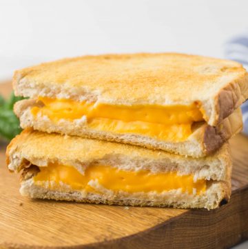 Air Fryer Grilled Cheese sandwich placed on a wooden board