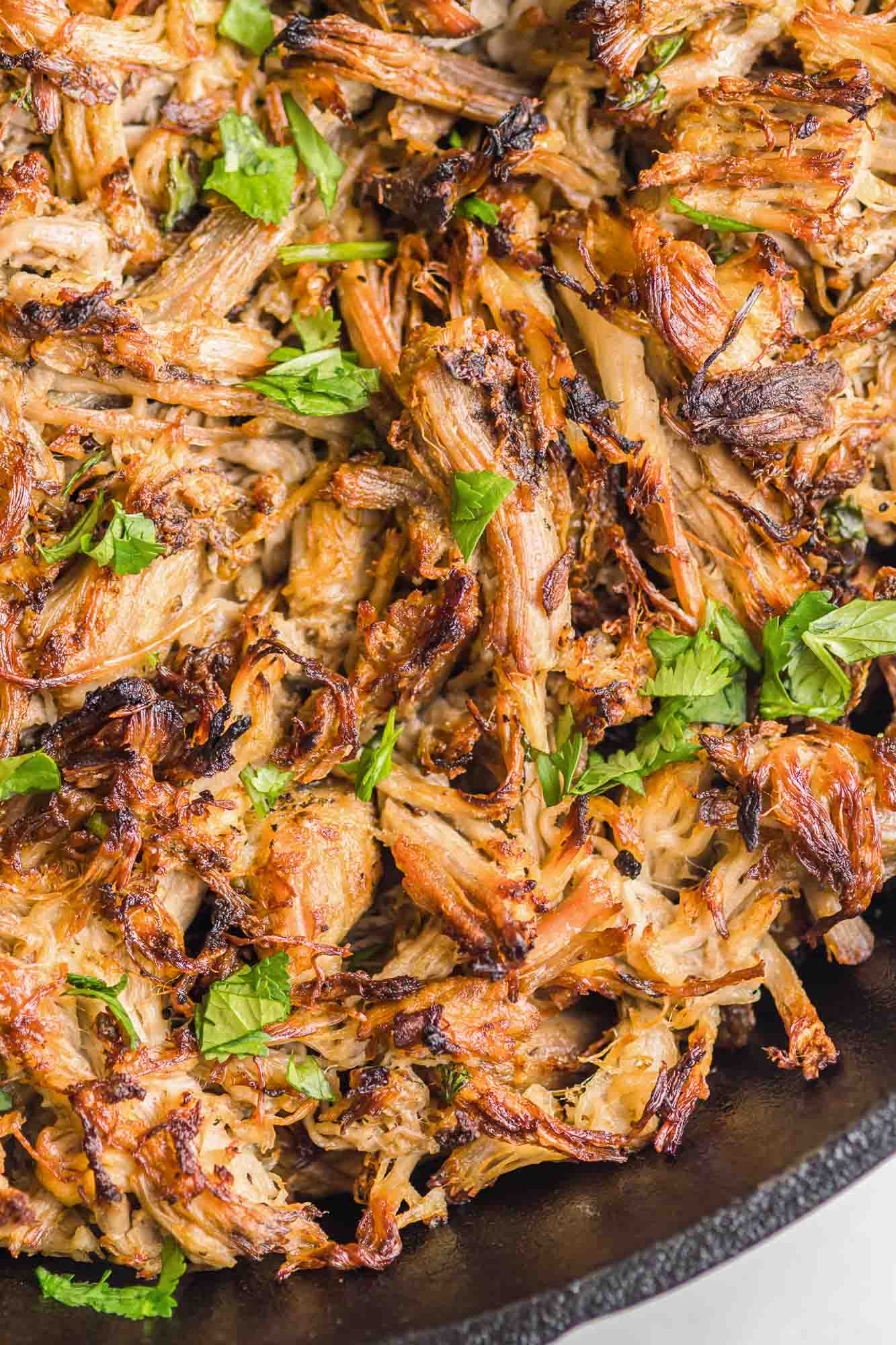 Crispy Instant Pot Carnitas decorated with chopped fresh parsley 