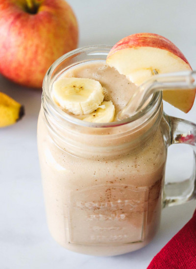 Apple banana smoothie served in a large glass jar, with a glass straw