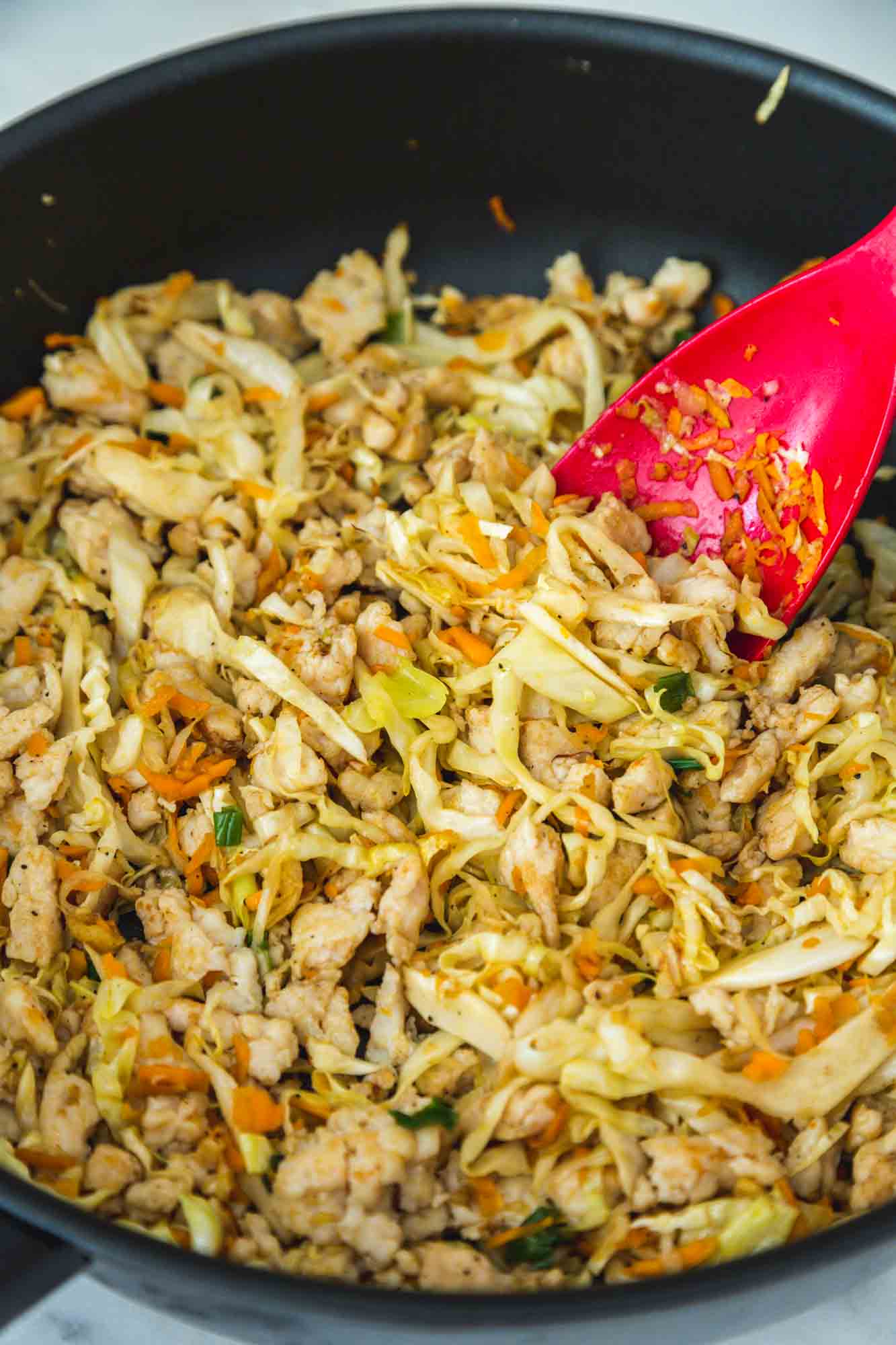 Cooking egg roll bowl in a large skillet