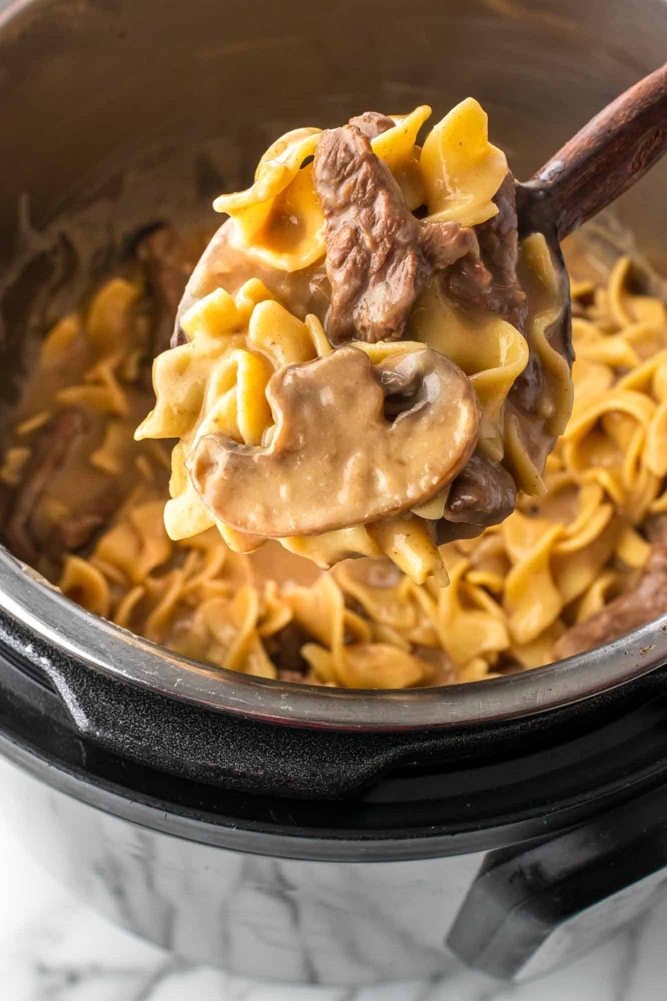 Close up of Beef Stroganoff on a wooded serving spoon