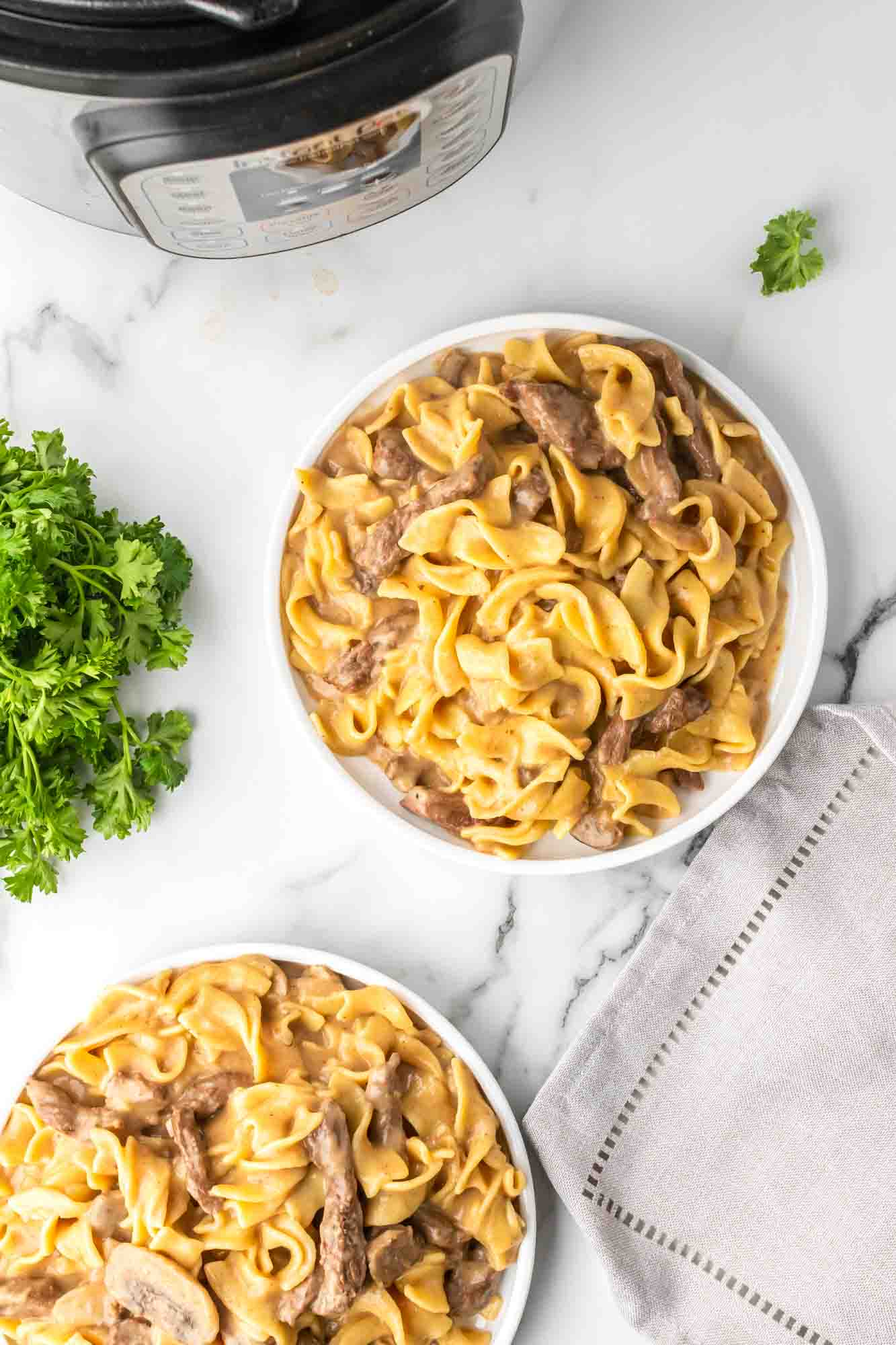Instant Pot Beef Stroganoff served in two white plates