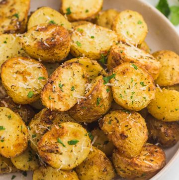 Perfectly golden roasted baby potatoes served on a plate