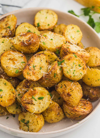 Perfectly golden roasted baby potatoes served on a plate