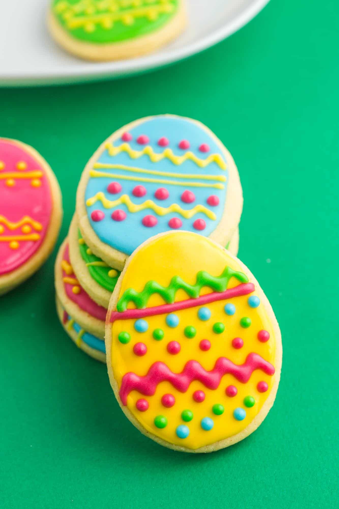 Decorated easter egg cookies on a dark green background