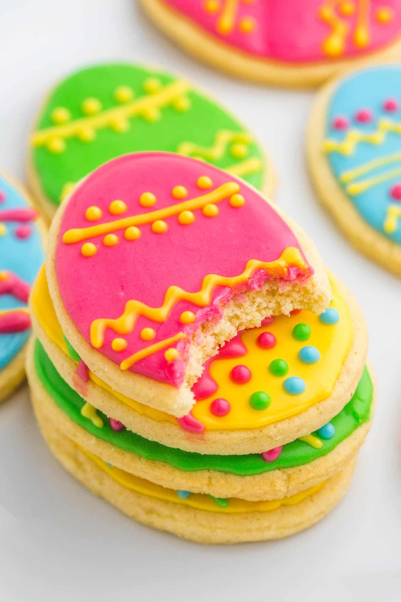 Easter egg sugar cookies stacked showing a bite shot