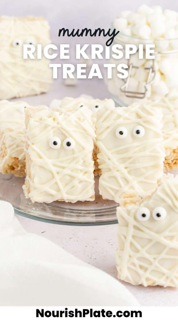 Mummy Rice Krispie Treats with candy eyes, standing on a glass plate. And overlay text that says "mummy rice krispie treats"