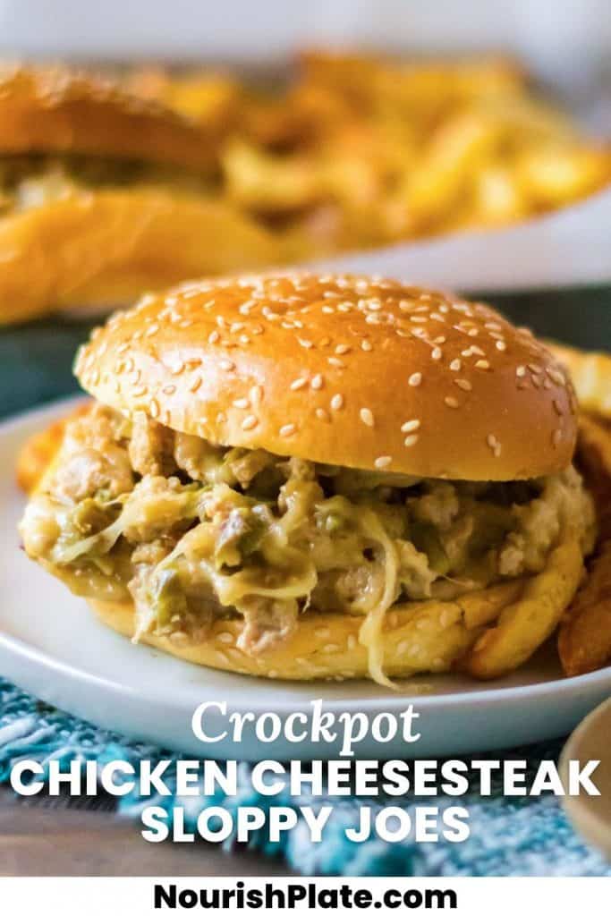 'A hamburger bun with cheesy chicken sloppy joes, on a plate. And overlay text that says "Crockpot Chicken Cheesesteak Sloppy Joes"