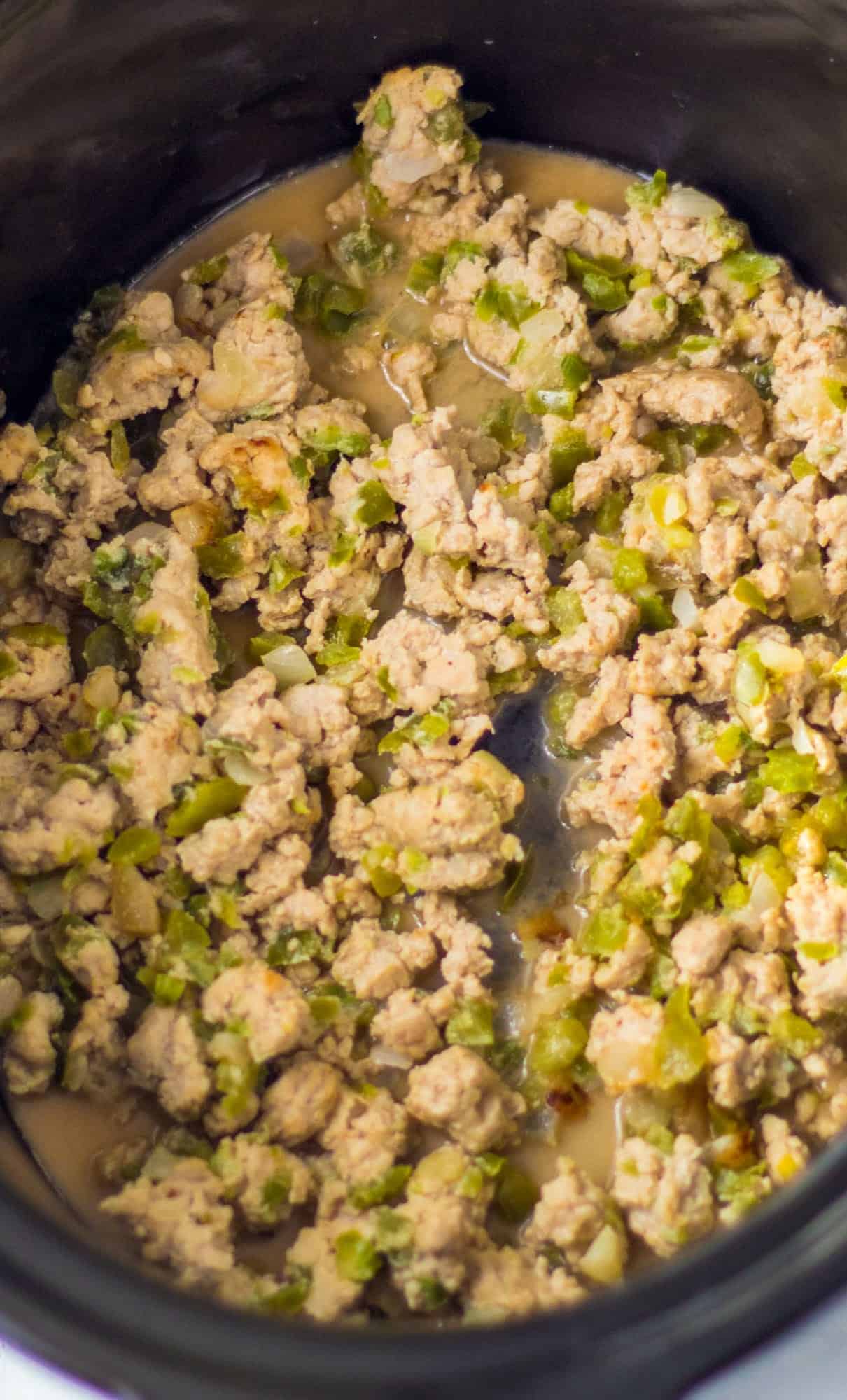 Chicken cheesesteak sloppy joes in a slow cooker.
