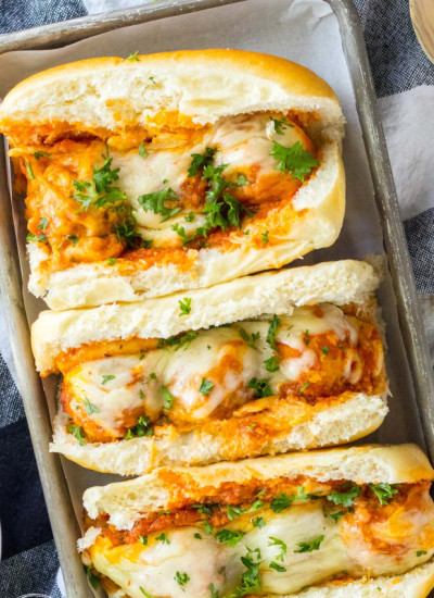 Overhead shot of chicken parm subs in a tray