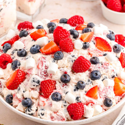 A large white bowl of berry cheesecake salad