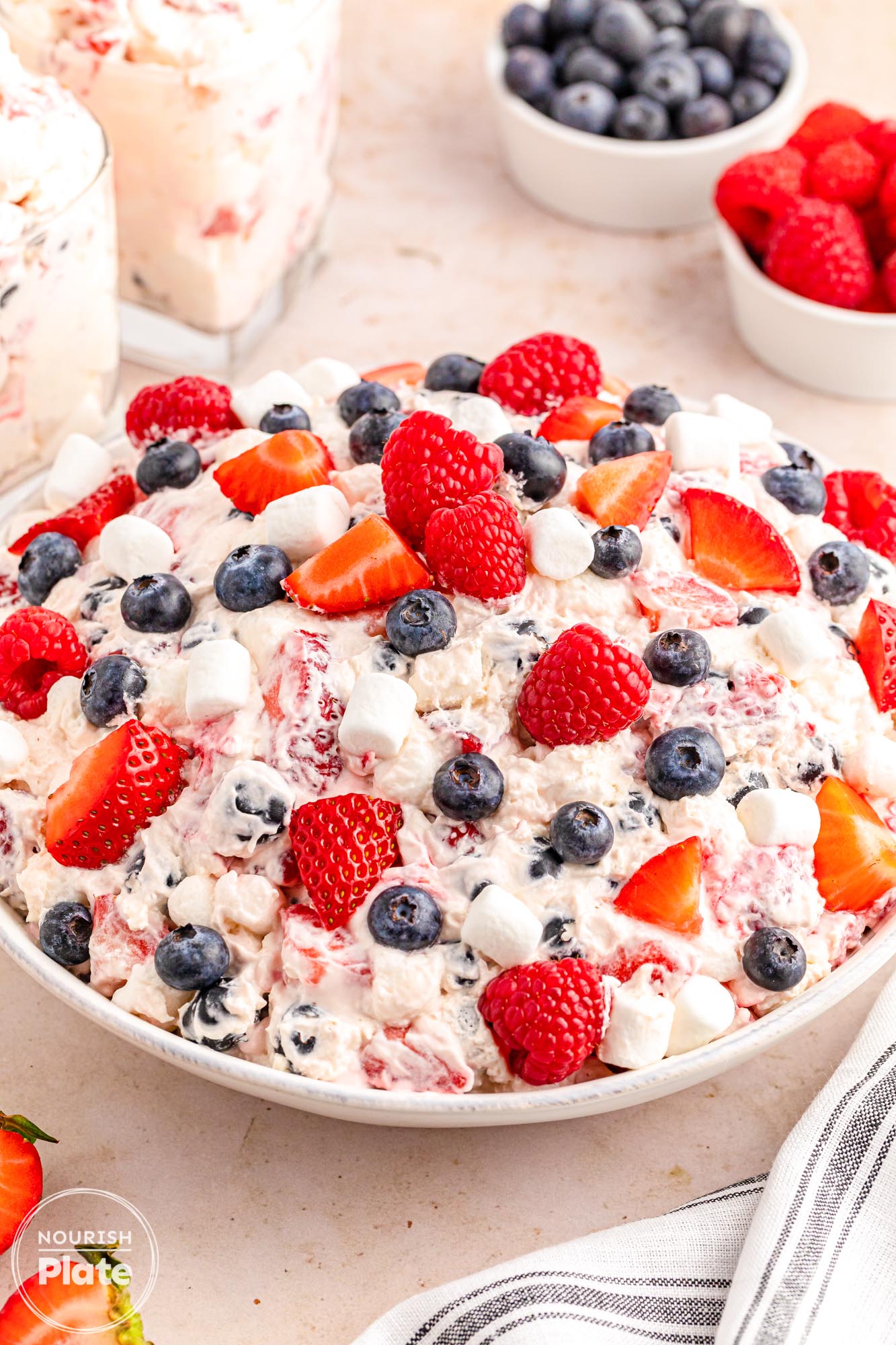 A large white bowl of berry cheesecake salad