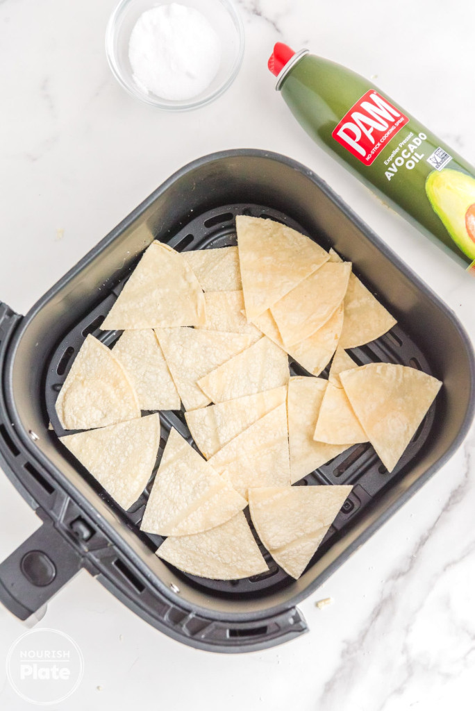tortilla chips in the air fryer basket before air frying