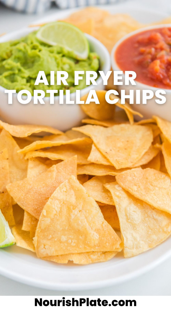 Crispy tortilla chips on a white platter, with 2 dips in the background (guacamole, and salsa). And overlay text that says "air fryer tortilla chips"