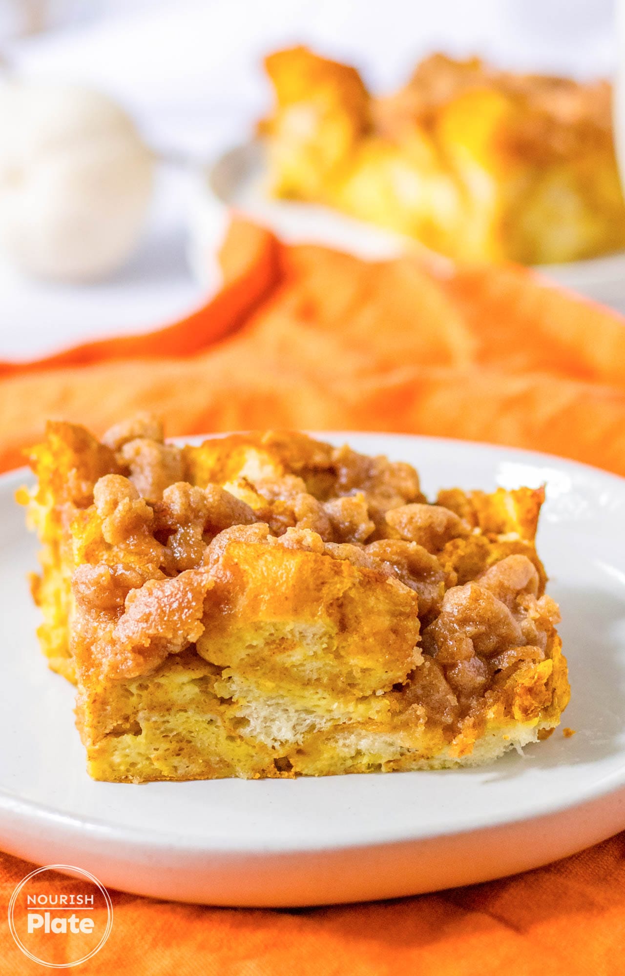 A piece of pumpkin french toast casserole served on a small white plate