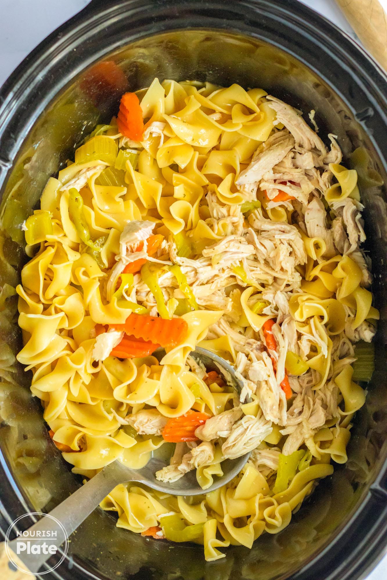 Overhead image of chicken noodle soup in a Crockpot