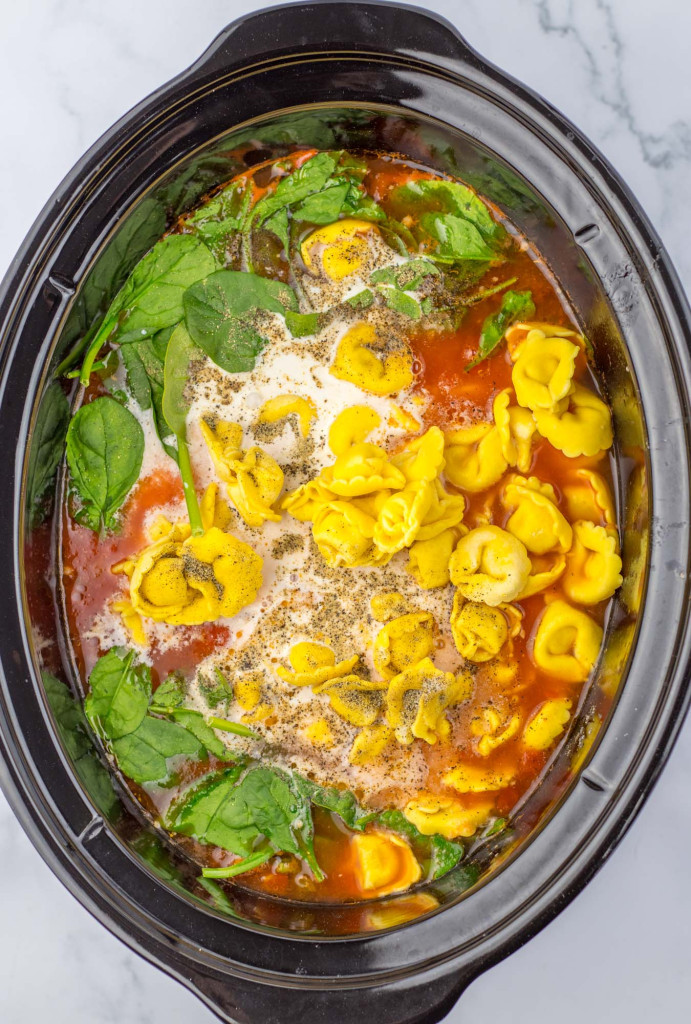 Added tortellini and spinach to the slow cooker