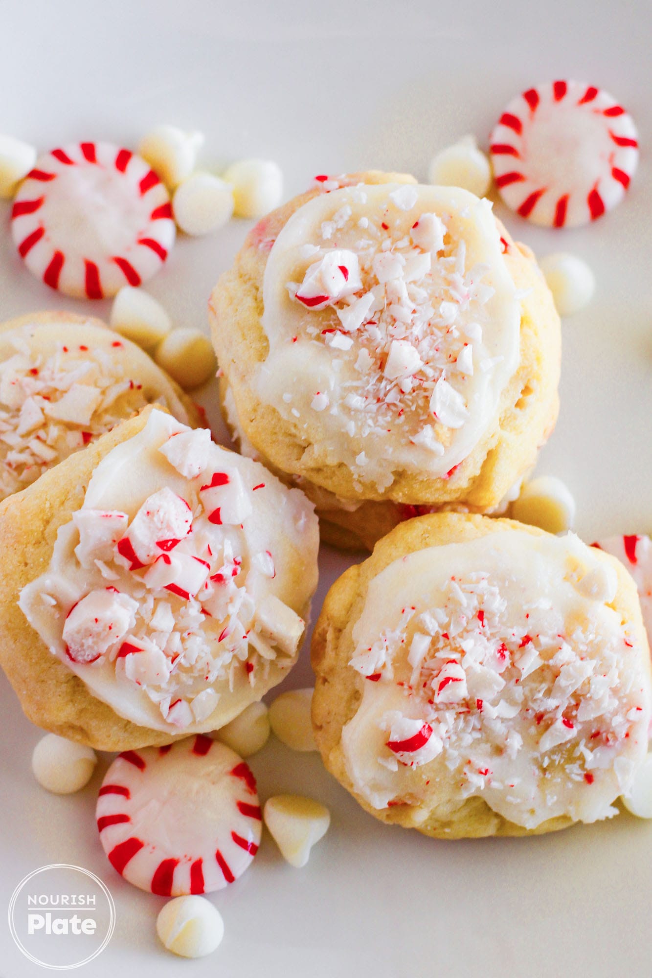 Overhead shot of 3 White Chocolate Peppermint Cookies, and peppermint candies.