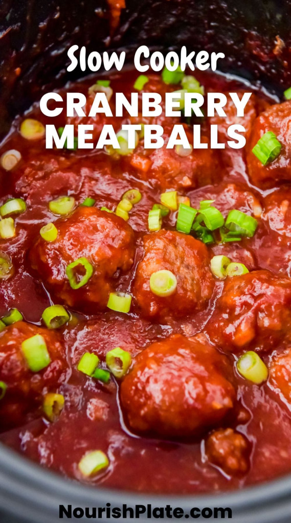 Cranberry meatballs in sauce in the slow cooker garnished with sliced green onions, and overlay text that says "slow cooker cranberry meatballs"