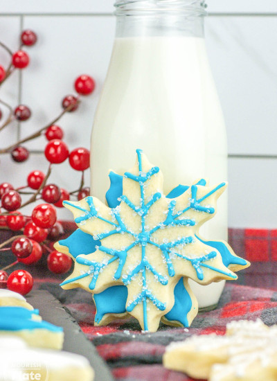 2 decorated sugar cookies shaped like snowflakes