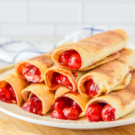 Stacked Cherry Cheesecake Taquitos on a plate
