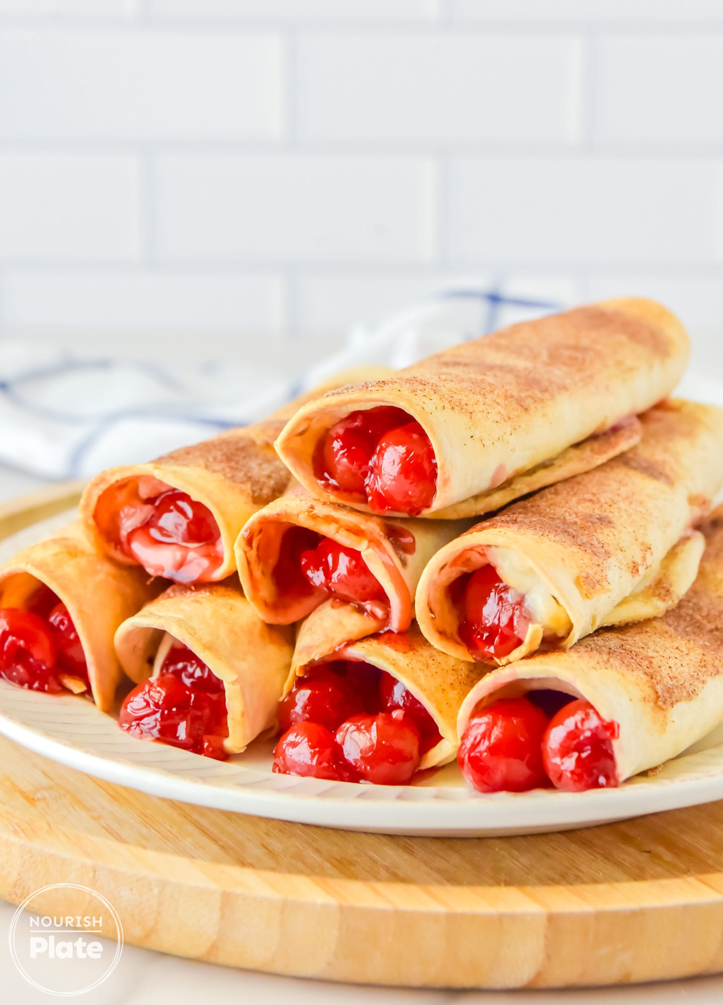 Stacked Cherry Cheesecake Taquitos on a plate