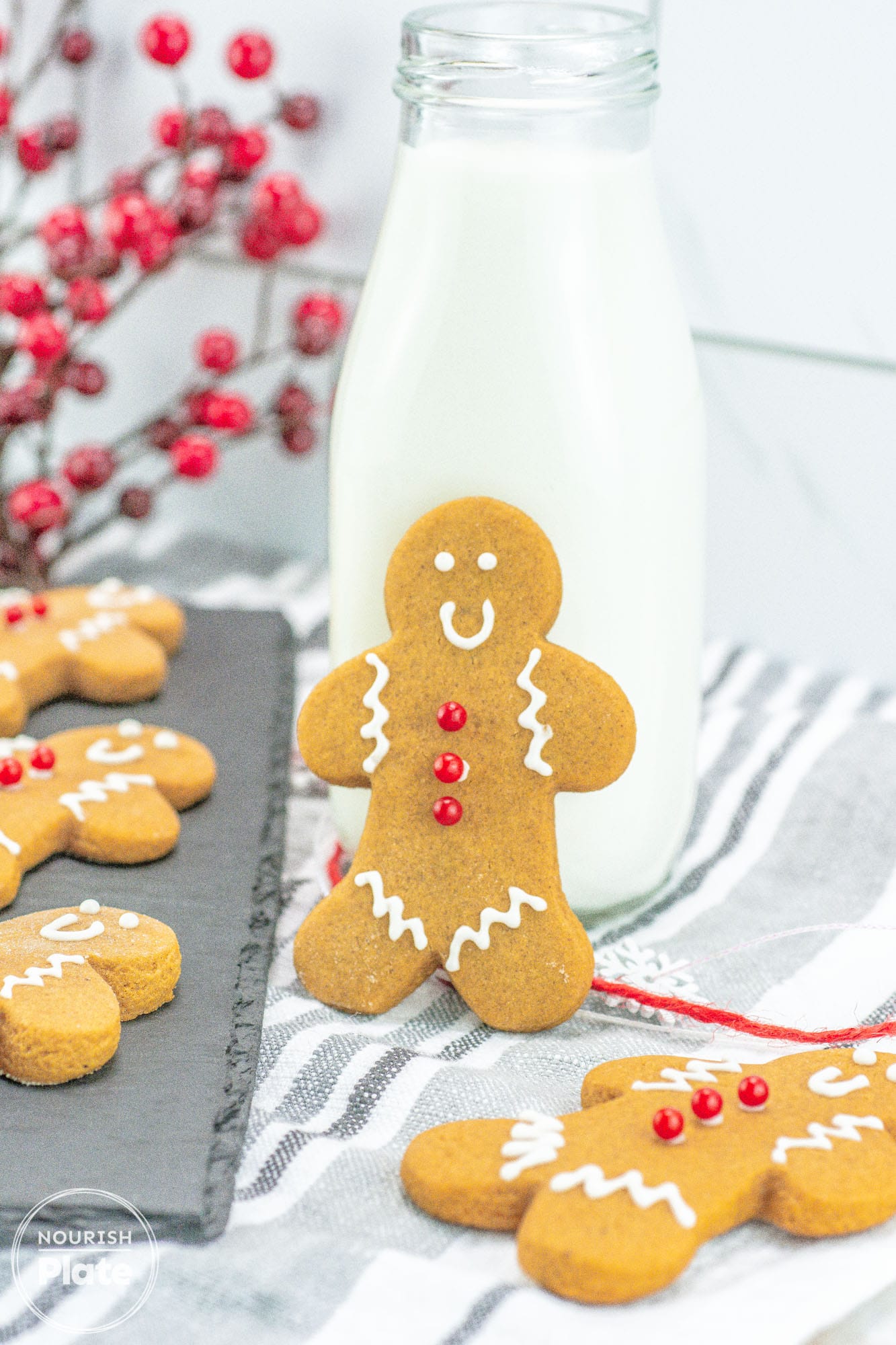 Classic Gingerbread Cookie standing against a bottle of milk, with more cookies on the sides.