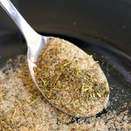 Meatloaf seasoning in a black bowl, with a spoon