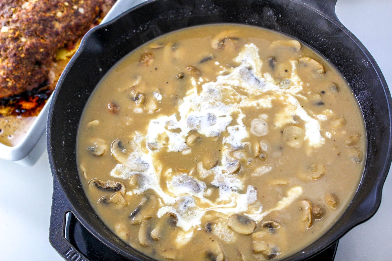 Mushroom sauce in a pan with cream added