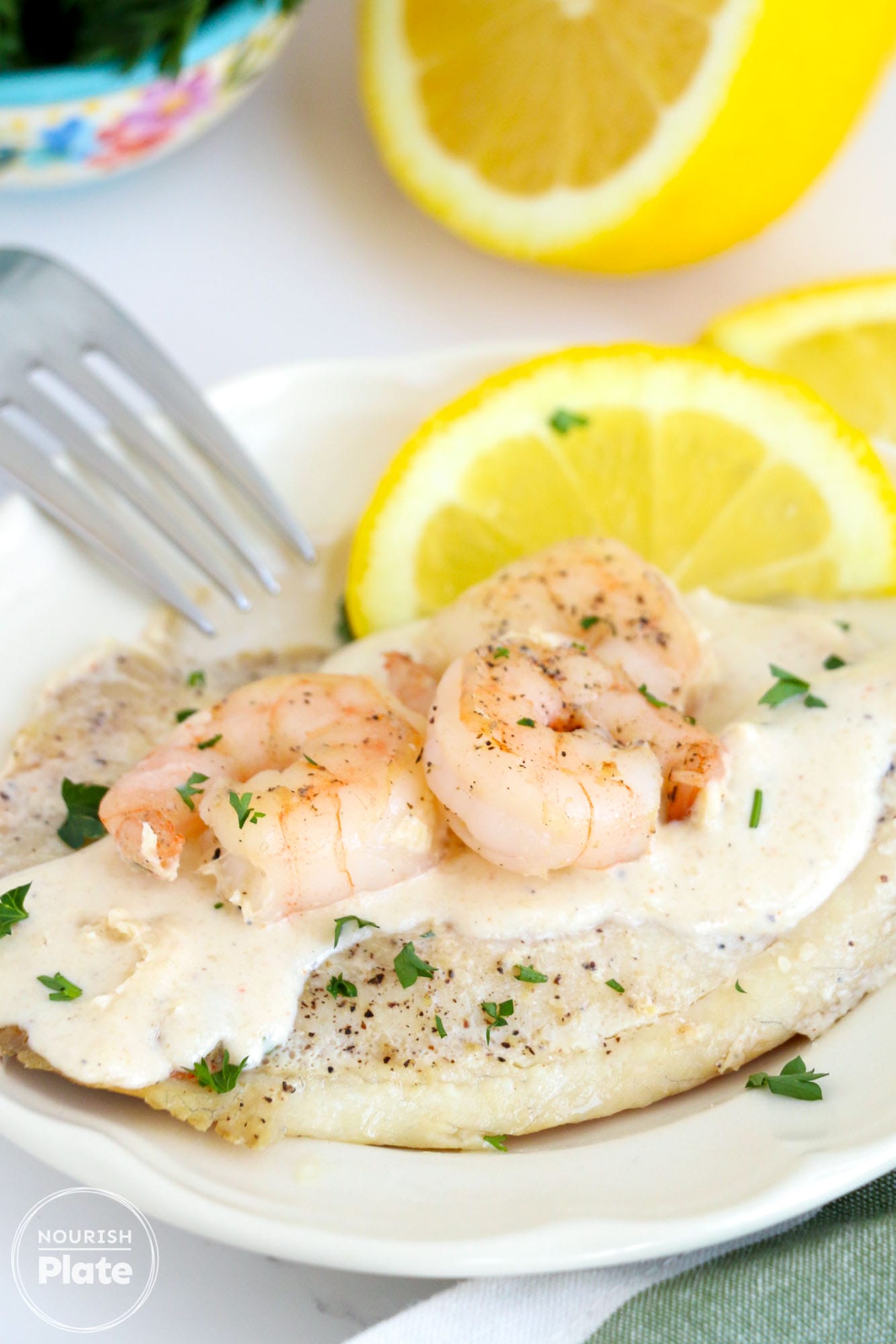 Pan Seared Tilapia and Shrimp on a plate, image taken from an angle