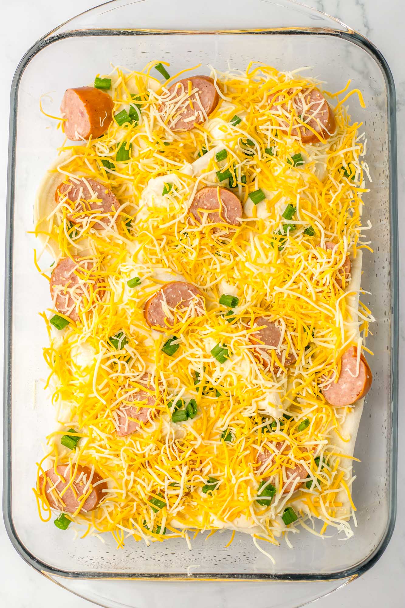 pierogi casserole covered with cheese before baking