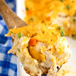 Close up shot of a serving spoon with chicken pot pie bubble casserole