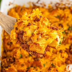 Taking a spoonful of sloppy joe bubble up casserole from the casserole dish