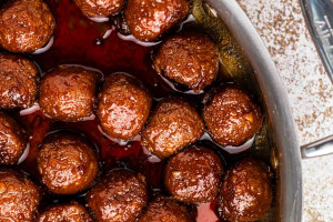 Close up shot of fully cooked asian glazed meatballs in a pan